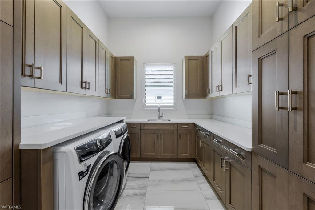 18250 Blue Eye Loop Fort Myers, FL 33913 - Photo 30 of 48 a utility room with a sink a washer and dryer