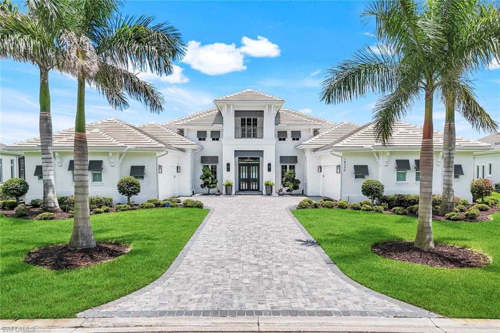 18250 Blue Eye Loop Fort Myers, FL 33913 - Photo 3 of 48 front view of a house with a yard and palm trees