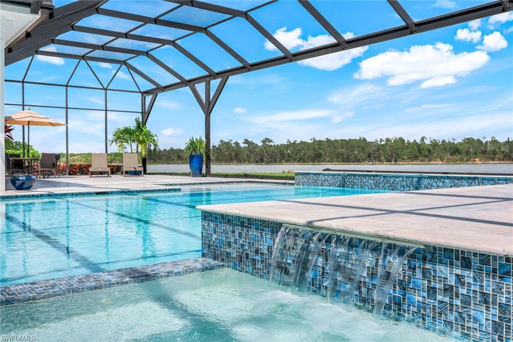 18250 Blue Eye Loop Fort Myers, FL 33913 - Photo 4 of 48 a view of a swimming pool with a patio and a yard
