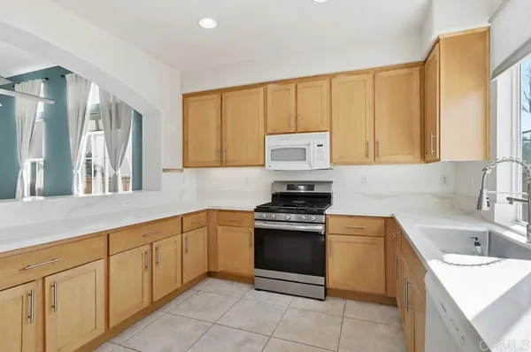 a kitchen with stainless steel appliances granite countertop a sink stove and cabinets
