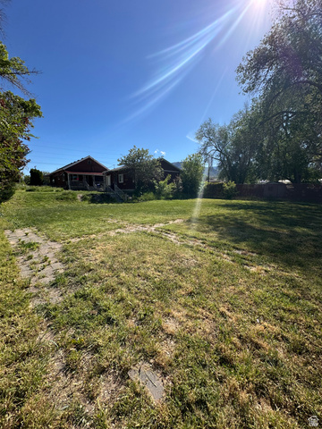 8320 West 3100th Street South Magna, UT 84044 - Photo 28 of 41 View of yard with a porch