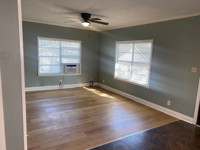 4859 Harrison Avenue Groves, TX 77619 - Photo 13 of 14 an empty room with wooden floor and windows
