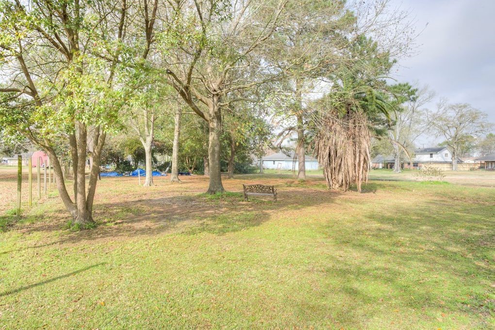 4859 Harrison Avenue Groves, TX 77619 - Photo 8 of 14 a view of yard with tree