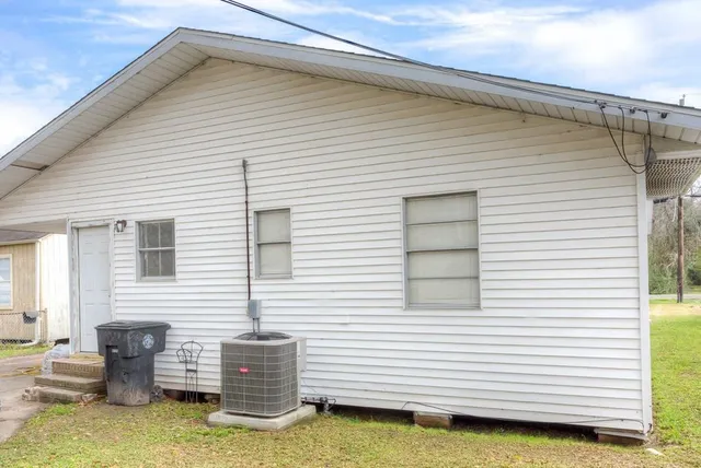 a view of backyard of house with outdoor seating