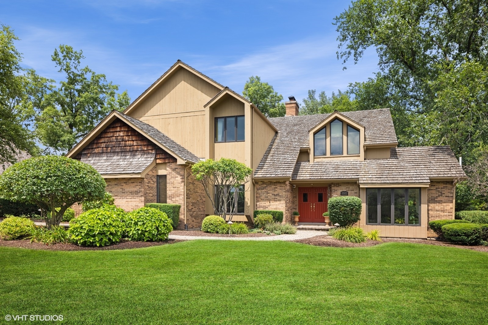 11522 Ridgewood Lane Burr Ridge, IL 60527 - Photo 1 of 47 a front view of a house with a yard and garage