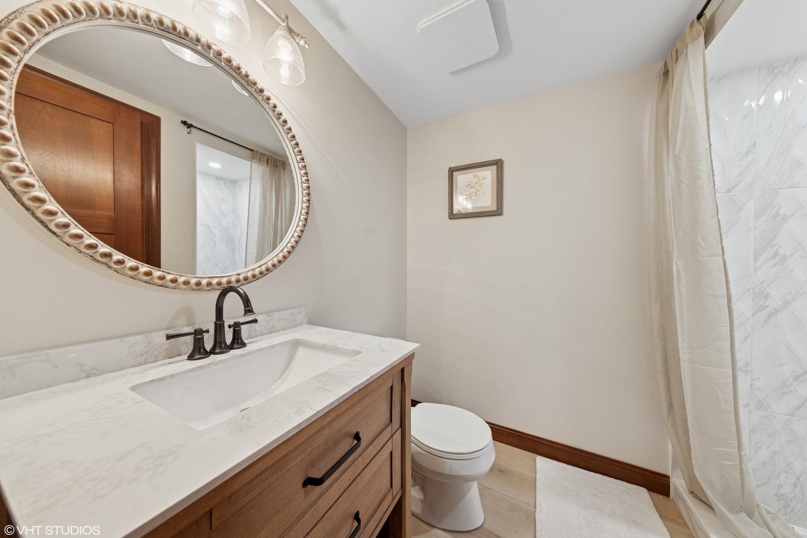 11522 Ridgewood Lane Burr Ridge, IL 60527 - Photo 29 of 47 a bathroom with a sink a toilet and mirror