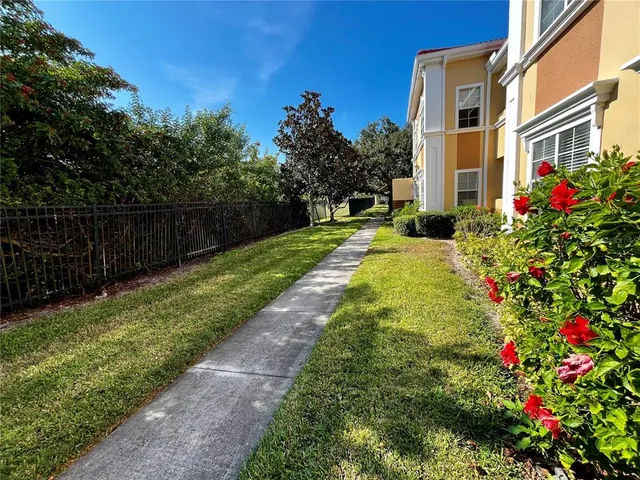 a view of a pathway with a house front of the house