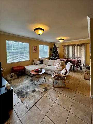 a living room with furniture a window and a bookshelf