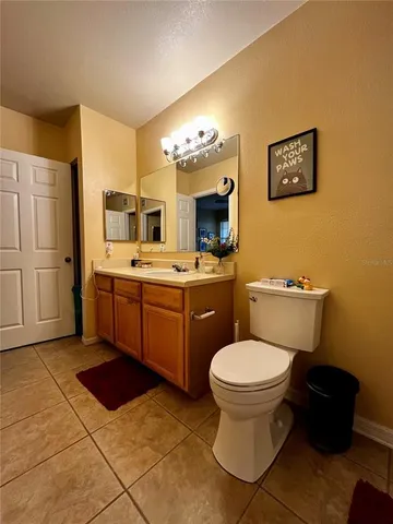 a spacious bathroom with a toilet sink and mirror