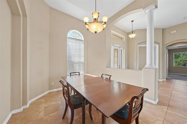 a view of a dining room with furniture and chandelier