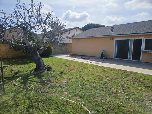 a backyard of a house with yard and barbeque oven