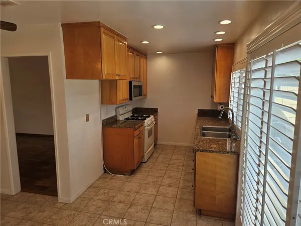 a kitchen with a refrigerator and a stove