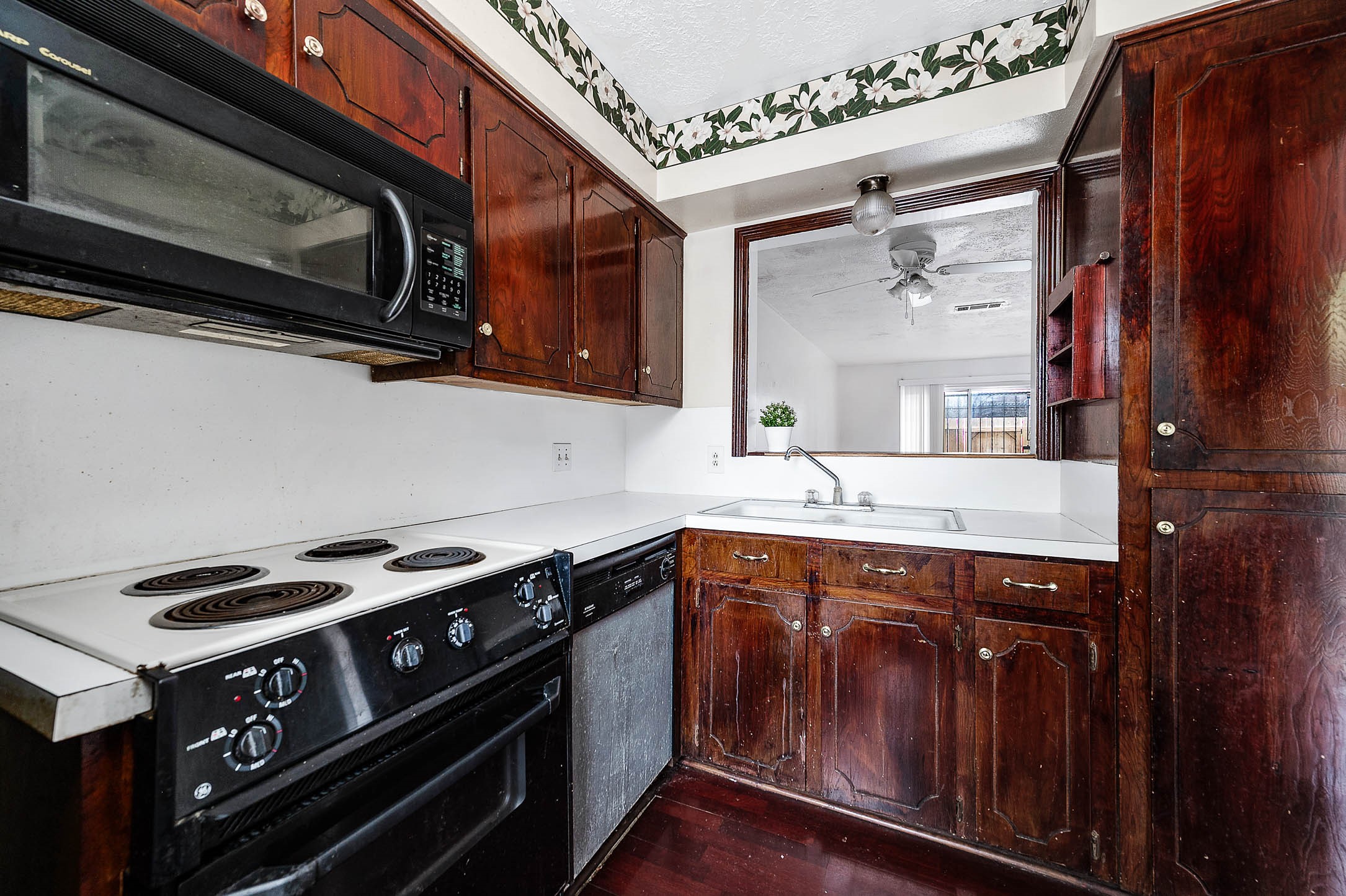1609 Mapleton Drive Houston, TX 77043 - Photo 7 of 21 a kitchen with stainless steel appliances granite countertop a stove and a microwave