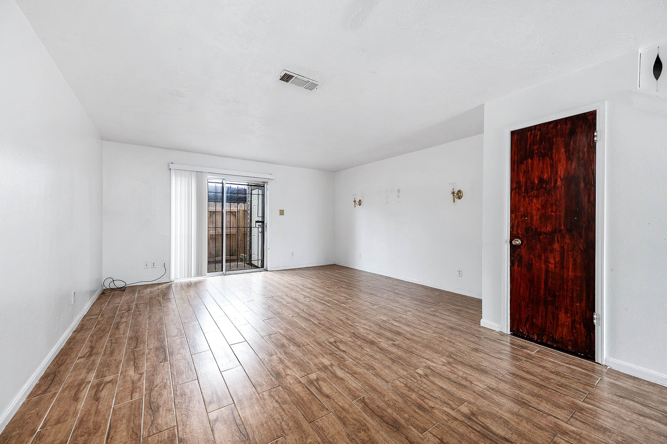 1609 Mapleton Drive Houston, TX 77043 - Photo 9 of 21 a view of an empty room with wooden floor and a window