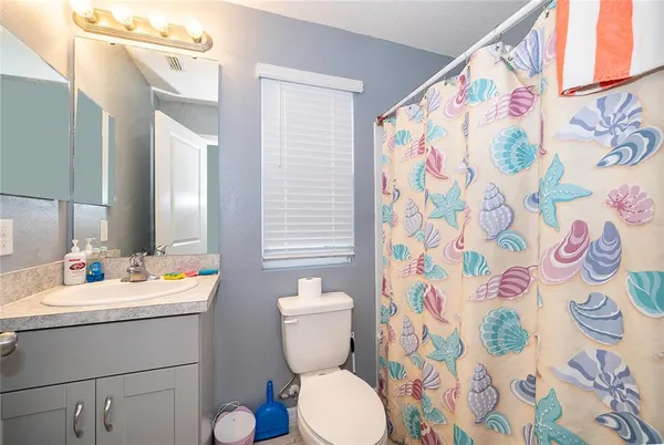 a bathroom with a sink and mirror with toilet
