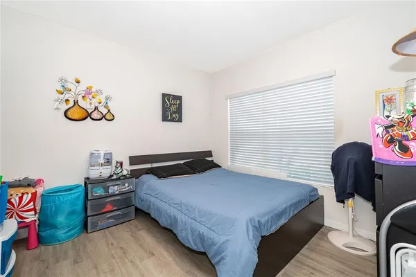 a bedroom with bed and a window