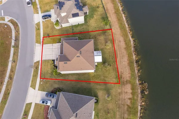 an aerial view of a house with outdoor space