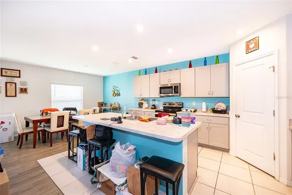 a kitchen with a table chairs and a refrigerator