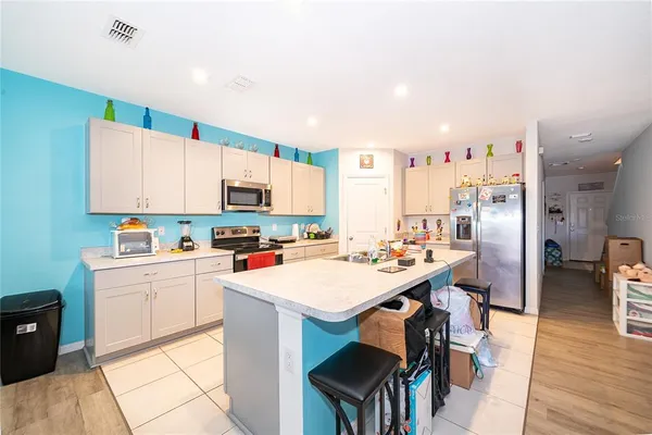 a kitchen with stainless steel appliances a stove a sink dishwasher and a refrigerator