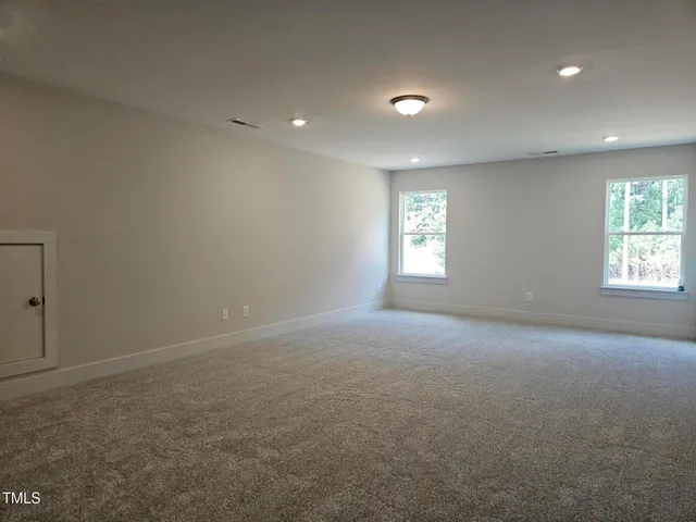 an empty room with windows and closet in a room