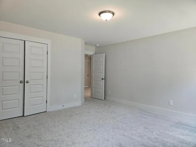 an empty room with closet area