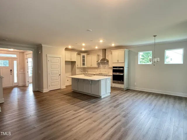a large kitchen with a lot of counter space and a wooden floor