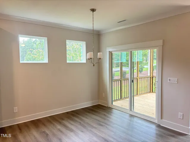 a large kitchen with a center island and wooden floor