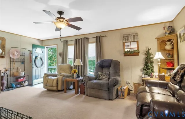 a living room with furniture a ceiling fan and a window
