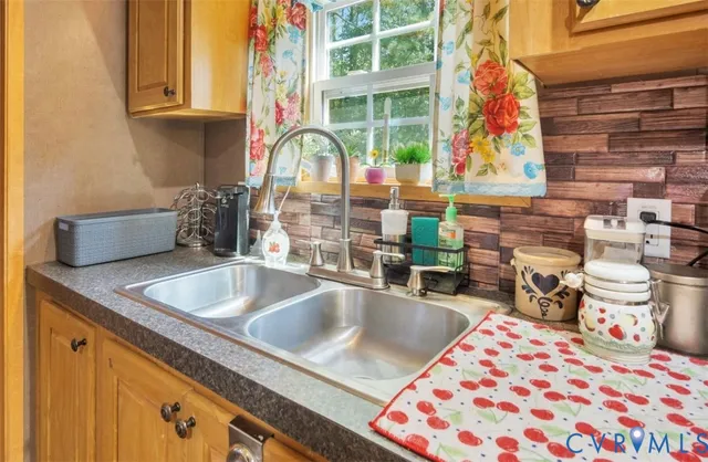 a living room with a sink and a large window
