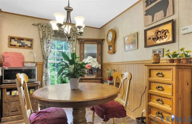a view of a dining room with furniture and chandelier