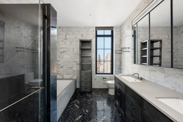 a bathroom with a double vanity sink a mirror and a shower