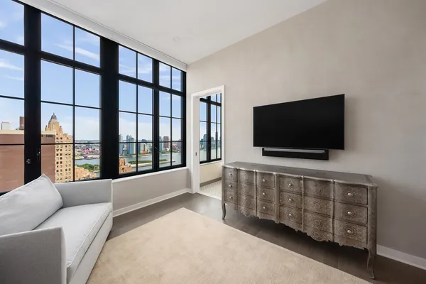 a living room with furniture and a flat screen tv