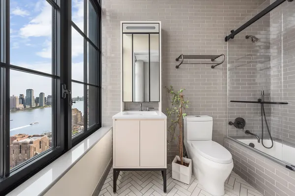 a bathroom with a toilet a sink and shower