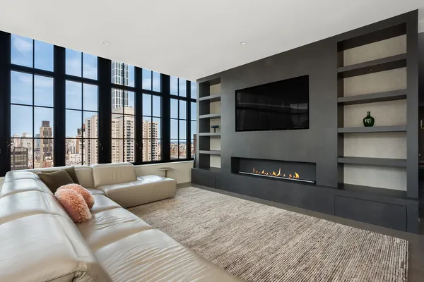 a living room with a flat screen tv and a fireplace