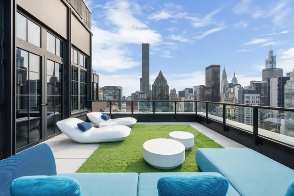 a view of a balcony with couch and chairs
