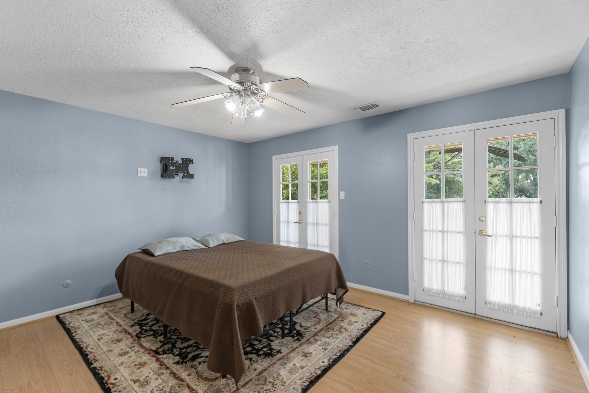 16114 Kempton Park Drive Spring, TX 77379 - Photo 16 of 22 a bedroom with a bed and wooden floor