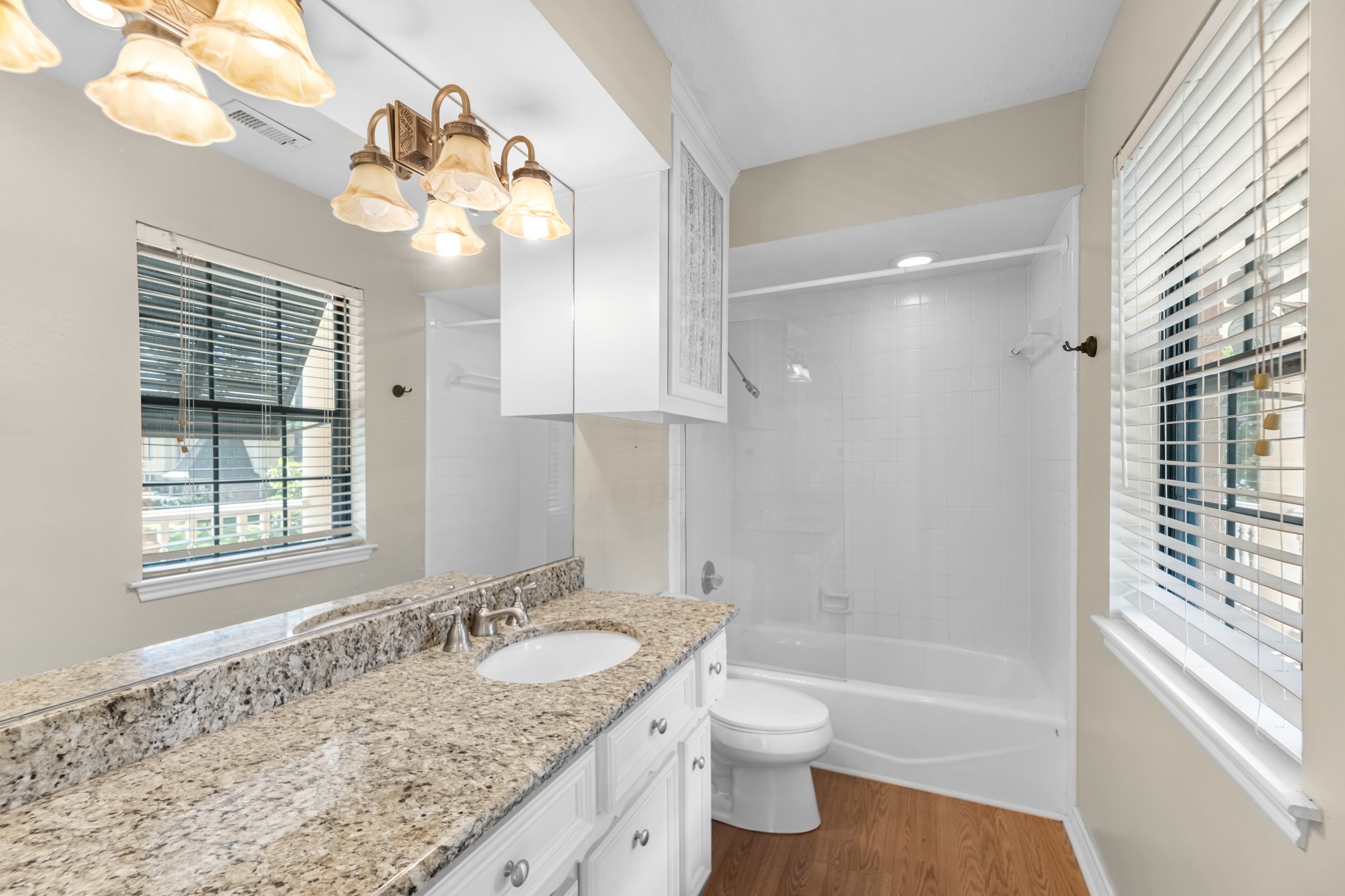 16114 Kempton Park Drive Spring, TX 77379 - Photo 19 of 22 a bathroom with a granite countertop sink a toilet and bathtub