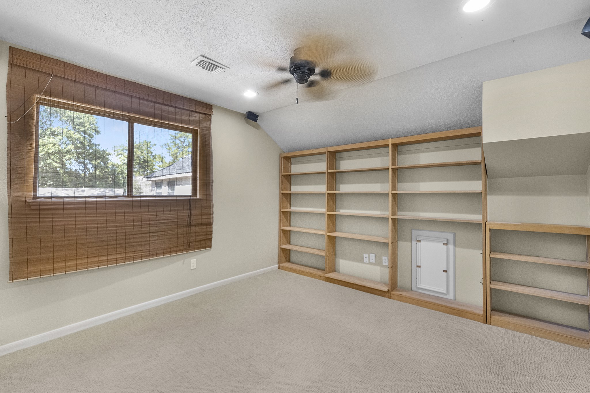 16114 Kempton Park Drive Spring, TX 77379 - Photo 20 of 22 a view of an empty room with a cabinet and a window