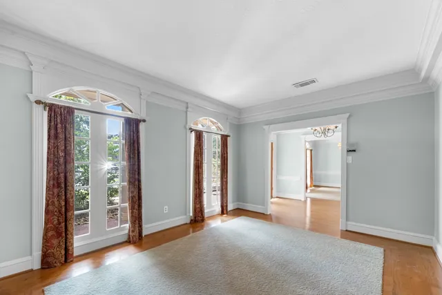 an empty room with windows and entrance