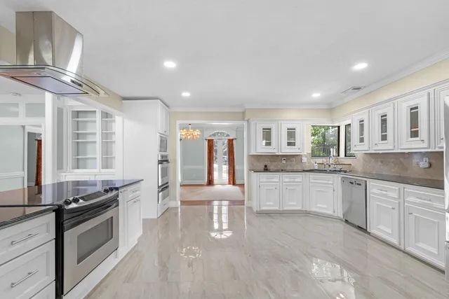 a kitchen with stainless steel appliances granite countertop a stove and cabinets
