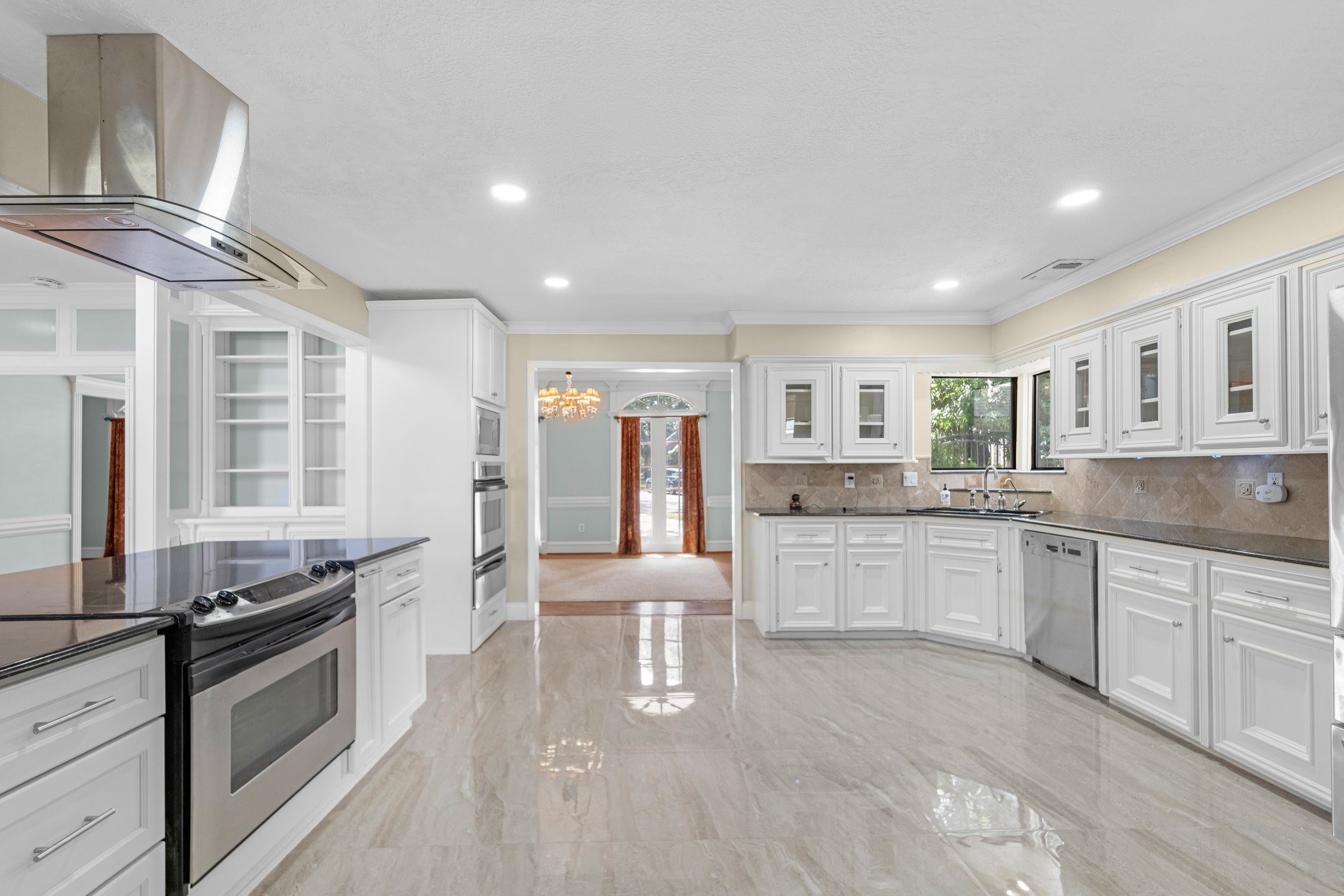 16114 Kempton Park Drive Spring, TX 77379 - Photo 9 of 22 a kitchen with stainless steel appliances granite countertop a stove and cabinets
