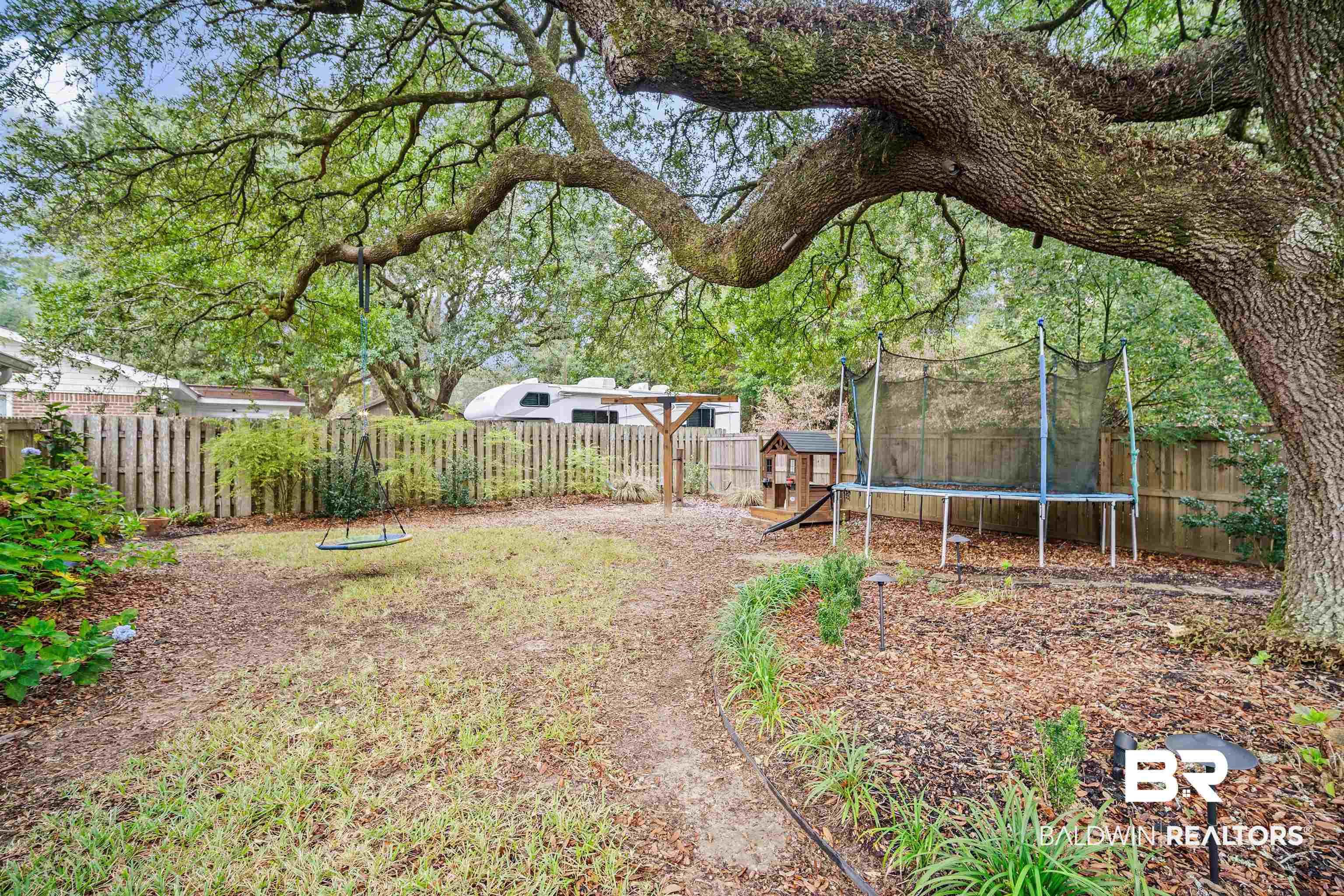 4228 Spring Valley Drive South Mobile, AL 36693 - Photo 31 of 31 View of yard featuring a playground and a trampoline