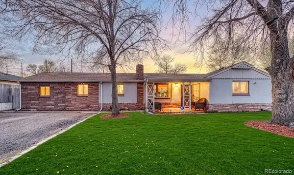 a view of a house with a yard porch and sitting area
