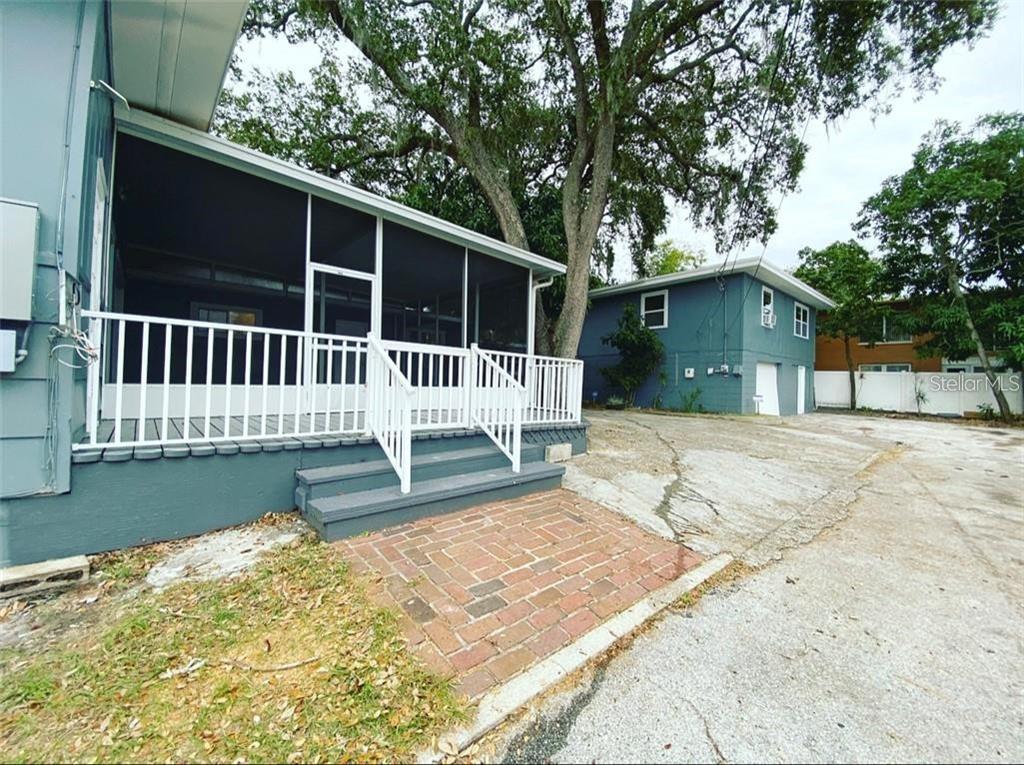 16 Jeff Road Largo, FL 33774 - Photo 13 of 14 a porch with a bench next to a yard