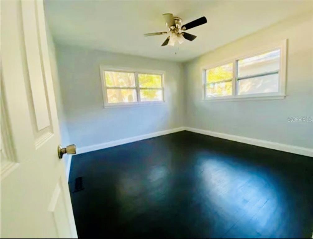 16 Jeff Road Largo, FL 33774 - Photo 6 of 14 a view of empty room with wooden floor and fan