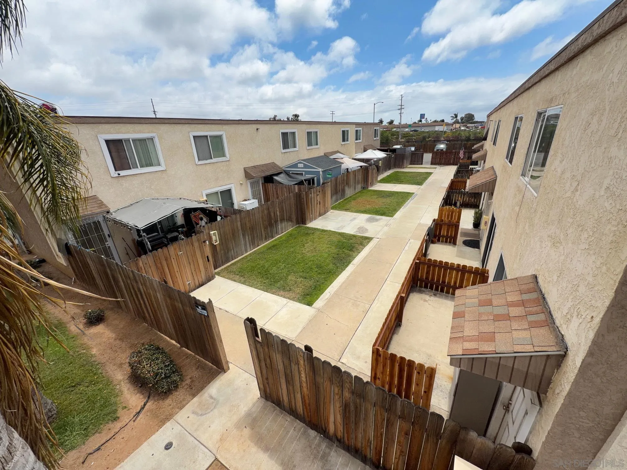 1054-1058 Outer Road San Diego, CA 92154 - Photo 7 of 14 a view of a patio with table and chairs with wooden floor and fence