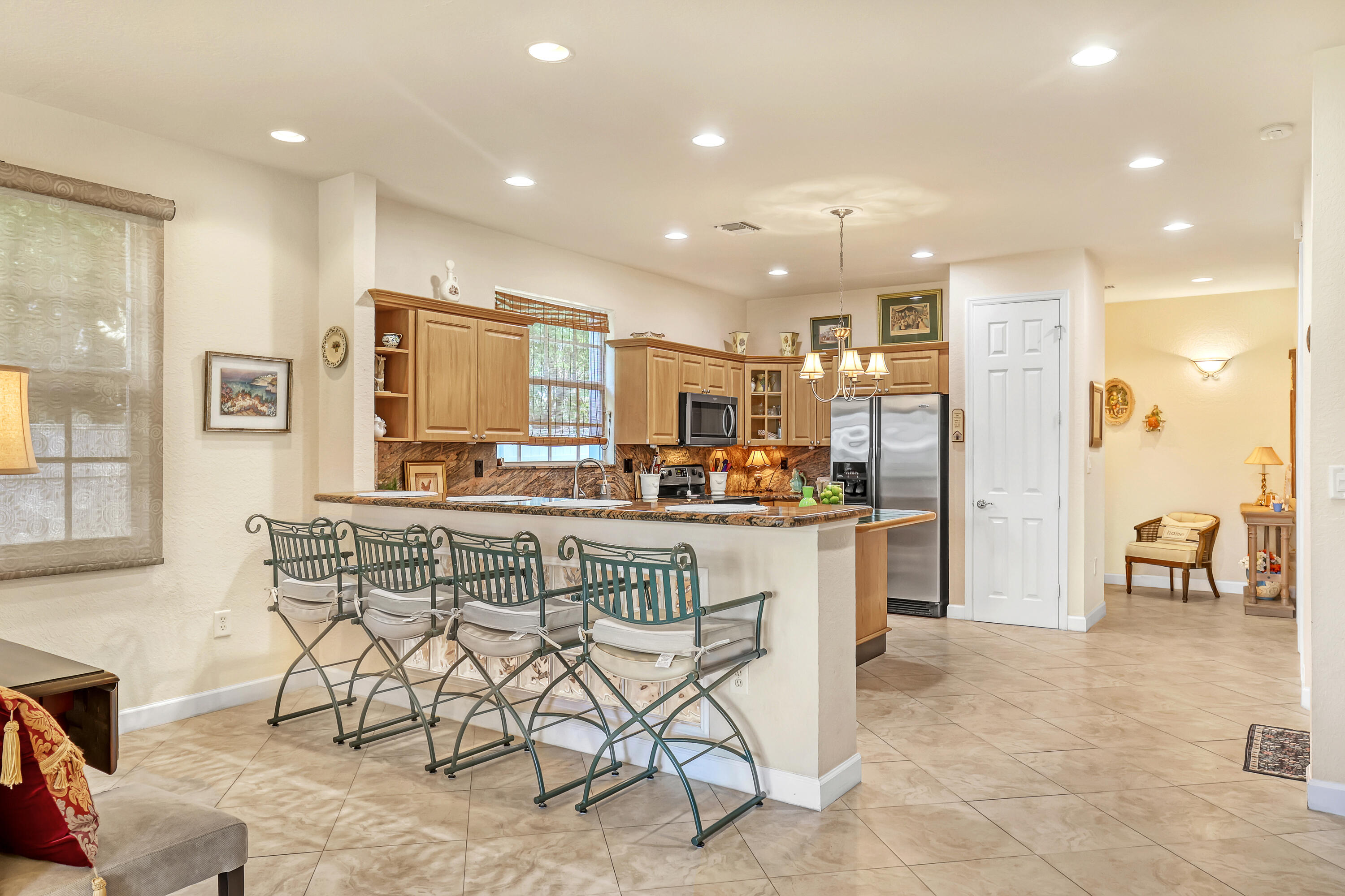 2560 Northeast 11th Street Pompano Beach, FL 33062 - Photo 5 of 18 a kitchen with stainless steel appliances granite countertop a stove a sink and a refrigerator