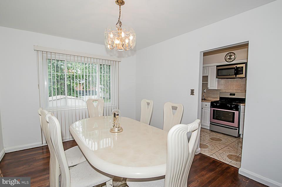 1072 Craftswood Road Baltimore, MD 21228 - Photo 3 of 18 a view of a dining room with furniture window and wooden floor