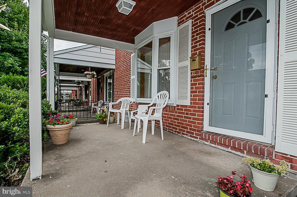 1072 Craftswood Road Baltimore, MD 21228 - Photo 5 of 18 a view of a patio with table and chairs and potted plants