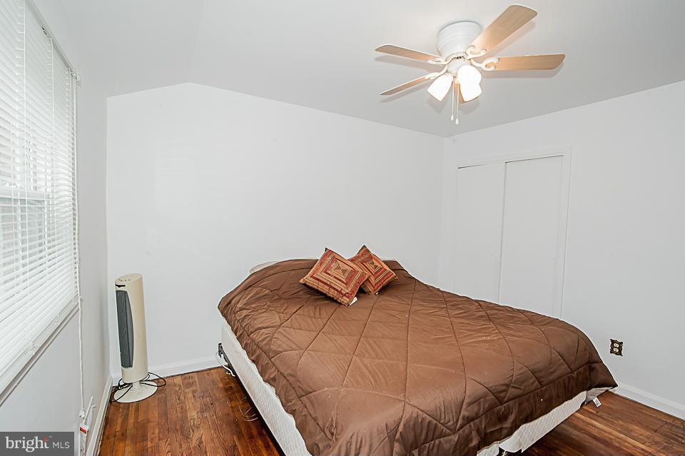 1072 Craftswood Road Baltimore, MD 21228 - Photo 9 of 18 a bedroom with a bed and a chandelier